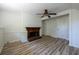 Bright living room featuring hardwood floors and a fireplace, perfect for relaxing and entertaining at 6136 Marbut Rd, Lithonia, GA 30058