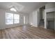 Living room with vaulted ceilings, wood floors, large windows, and view of the front entrance and staircase at 6136 Marbut Rd, Lithonia, GA 30058
