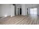Bright living room featuring wood floors, staircase, and access to the kitchen and outdoor deck at 6136 Marbut Rd, Lithonia, GA 30058
