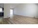 Bright and spacious living room featuring new wood floors, a sliding glass door, and a neutral color palette at 6136 Marbut Rd, Lithonia, GA 30058