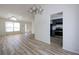 Open-concept living area with wood floors, vaulted ceilings, modern lighting, and an adjacent, renovated kitchen at 6136 Marbut Rd, Lithonia, GA 30058