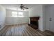 Bright living room featuring hardwood floors and a fireplace, perfect for relaxing and entertaining at 6136 Marbut Rd, Lithonia, GA 30058