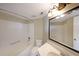 Clean bathroom with a bathtub, a toilet, a large mirror, and a sink with vanity at 795 Hammond Dr # 1108, Atlanta, GA 30328