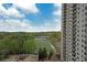 High-rise apartment building overlooks parking and a playing field surrounded by trees and a clear blue sky at 795 Hammond Dr # 1108, Atlanta, GA 30328