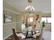 Bright dining area with modern chandelier and glass table, staged with decor at 795 Hammond Dr # 1108, Atlanta, GA 30328