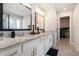 Bright bathroom featuring dual sinks, granite countertops, and a walk-in closet at 2320 Ridge View Dr, Loganville, GA 30052