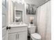 Cozy bathroom with modern fixtures, a decorative mirror and a toilet with closed lid at 2320 Ridge View Dr, Loganville, GA 30052