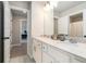 Well-lit bathroom with double sinks, white cabinets and modern fixtures at 2320 Ridge View Dr, Loganville, GA 30052