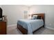 Comfortable bedroom with a bed featuring many decorative pillows, and a wooden dresser with a TV at 2320 Ridge View Dr, Loganville, GA 30052