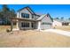 Charming two-story home featuring a covered porch and a two-car garage at 2320 Ridge View Dr, Loganville, GA 30052