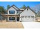 Charming two-story home featuring a covered porch and a two-car garage at 2320 Ridge View Dr, Loganville, GA 30052