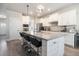 Modern kitchen with a large granite island, white cabinets, and stainless steel appliances at 2320 Ridge View Dr, Loganville, GA 30052