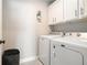 Functional laundry room with washer, dryer, and ample cabinet space at 2320 Ridge View Dr, Loganville, GA 30052