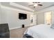 This main bedroom features a tray ceiling, television, and doorway to the en-suite bath at 2320 Ridge View Dr, Loganville, GA 30052