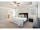 Relaxing main bedroom showcasing a tray ceiling, neutral walls, and natural light at 2320 Ridge View Dr, Loganville, GA 30052
