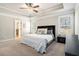 Comfortable main bedroom with natural light, a tray ceiling, and a ceiling fan at 2320 Ridge View Dr, Loganville, GA 30052