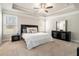 Comfortable main bedroom with natural light, a tray ceiling, and a ceiling fan at 2320 Ridge View Dr, Loganville, GA 30052