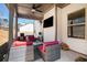 Covered patio with comfortable outdoor seating, ceiling fan, and a mounted television at 2320 Ridge View Dr, Loganville, GA 30052