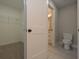 Bathroom with a toilet adjacent to a closet with wire shelving, providing both convenience and storage at 4850 Cool Springs Rd, Winston, GA 30187