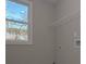 Bright laundry room with a window, wire rack shelving, and hookups for the washer and dryer at 4850 Cool Springs Rd, Winston, GA 30187