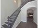 Staircase with decorative iron railing, leading to living room with fireplace at 4850 Cool Springs Rd, Winston, GA 30187