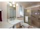 Bathroom featuring a marble vanity, shower with seat, and accessible features at 1497 Mason Mill Ne Rd, Atlanta, GA 30329