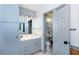 Bathroom featuring a sink vanity, toilet, lighting, and a doorway to another room at 1497 Mason Mill Ne Rd, Atlanta, GA 30329