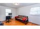 This bedroom features hardwood floors and two windows with blinds, and a futon at 1497 Mason Mill Ne Rd, Atlanta, GA 30329