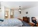 This bedroom features hardwood floors, an area rug, and a decorative hanging pendant light fixture at 1497 Mason Mill Ne Rd, Atlanta, GA 30329