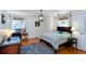 Bright bedroom boasts hardwood floors, area rug, desk, and a decorative hanging pendant light fixture at 1497 Mason Mill Ne Rd, Atlanta, GA 30329