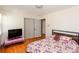 Bedroom featuring hardwood floors, closet, television, and floral patterned bedspread at 1497 Mason Mill Ne Rd, Atlanta, GA 30329