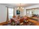 Elegant dining room featuring hardwood floors, large windows, and a stylish chandelier at 1497 Mason Mill Ne Rd, Atlanta, GA 30329