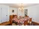 Traditional dining room featuring hardwood floors, chandelier lighting, and a dining table with a floral patterned tablecloth at 1497 Mason Mill Ne Rd, Atlanta, GA 30329