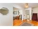 Bright hallway with hardwood floors, built-in bookshelves, a rocking chair, and stairway with patterned carpet at 1497 Mason Mill Ne Rd, Atlanta, GA 30329