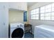 Well-lit laundry room with modern washer, dryer, and built-in storage cabinets for organization at 1497 Mason Mill Ne Rd, Atlanta, GA 30329