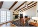 Inviting living room with vaulted ceilings, exposed beams, a fireplace, and hardwood floors at 1497 Mason Mill Ne Rd, Atlanta, GA 30329