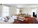 Spacious living room with large windows, hardwood floors, and a comfortable sectional sofa with throw pillows at 1497 Mason Mill Ne Rd, Atlanta, GA 30329