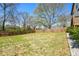 Expansive backyard with a lush lawn, surrounded by a privacy fence and mature trees at 3087 Alston Dr, Decatur, GA 30032