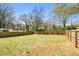 View of a large, grassy backyard with a wooden fence, perfect for outdoor activities at 3087 Alston Dr, Decatur, GA 30032