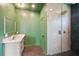 Modern bathroom featuring sleek vanity, large shower with glass door, and stylish light fixture at 3087 Alston Dr, Decatur, GA 30032