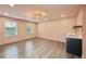 Large bonus room with hardwood floors, a modern light fixture, and a wet bar at 3087 Alston Dr, Decatur, GA 30032