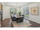 Bright dining room with modern decor including a long wooden table, elegant chandelier, and large windows at 3087 Alston Dr, Decatur, GA 30032