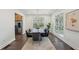 Elegant dining room features a long wooden table, modern chandelier, and ample natural light at 3087 Alston Dr, Decatur, GA 30032