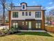 Modern farmhouse exterior with black framed windows, neutral siding, tidy front yard, and wood accents at 3087 Alston Dr, Decatur, GA 30032