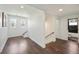 Hallway featuring hardwood floors, natural light, and access to an adjacent bathroom at 3087 Alston Dr, Decatur, GA 30032