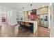 Kitchen with stainless appliances, tile backsplash, island with bar seating and pendant lighting at 3087 Alston Dr, Decatur, GA 30032