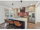 Kitchen with stainless appliances, tile backsplash, island with bar seating and pendant lighting at 3087 Alston Dr, Decatur, GA 30032
