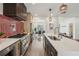 Kitchen with large island and bar seating, stainless appliances, and view to dining and living rooms at 3087 Alston Dr, Decatur, GA 30032