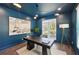 Stylish blue home office with ample natural light, modern lighting, and a contemporary desk at 3087 Alston Dr, Decatur, GA 30032