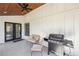 Covered porch with seating, grill, and stylish flooring, offering a comfortable outdoor space at 3087 Alston Dr, Decatur, GA 30032